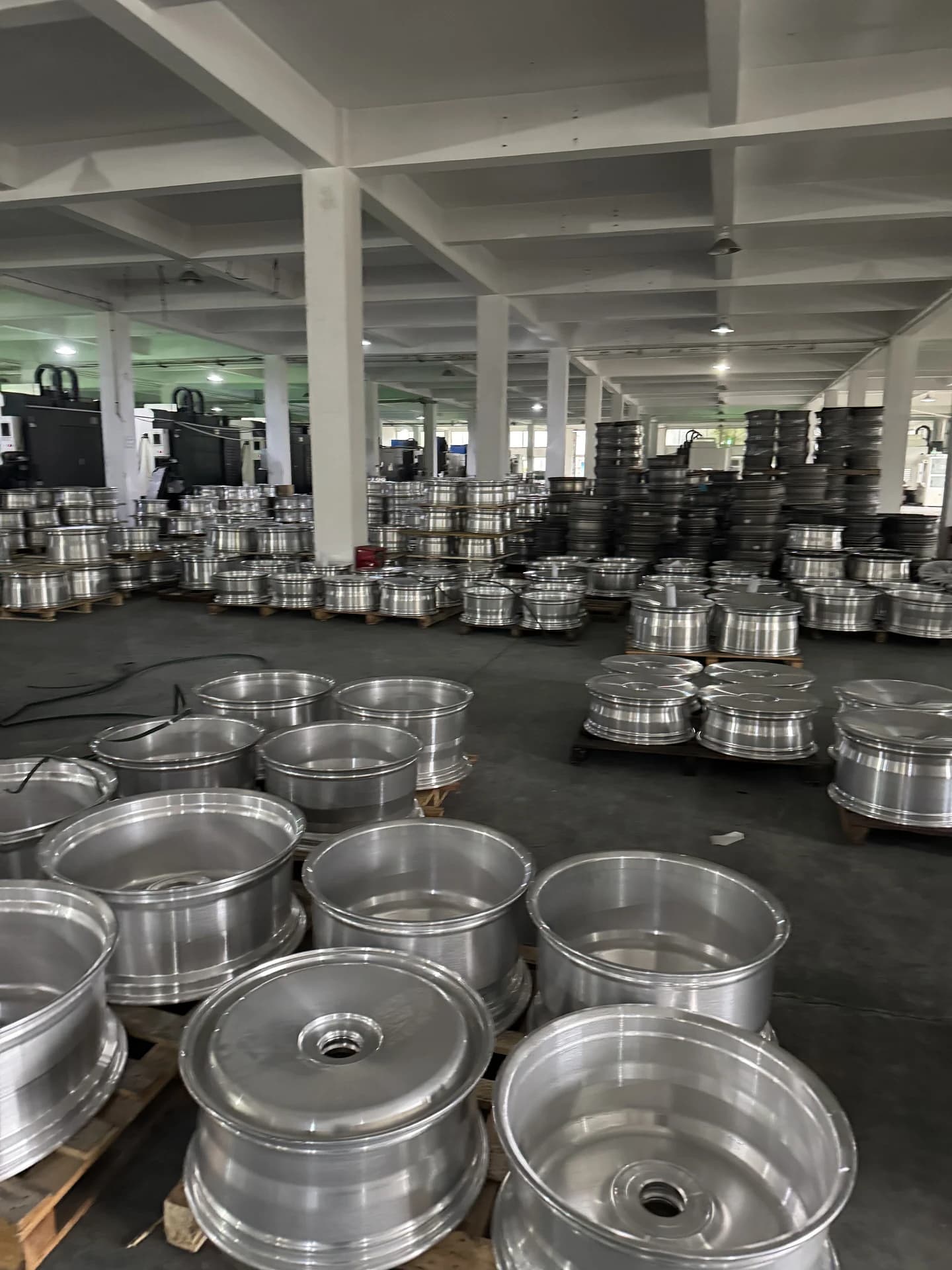 Warehouse full of stacked 6061-T6 aerospace aluminum forged wheel blanks